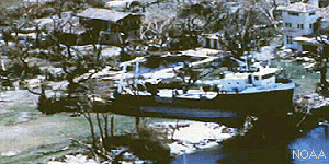 Photograph of boat carried inland by storm surge.